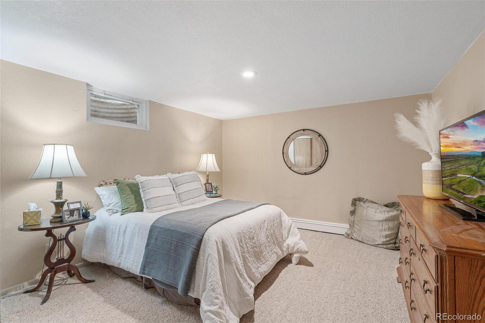 4155 Ingalls Street Wheat Ridge, CO 80033 - Photo 28 of 47 a bedroom with a bed and a lamp on dresser