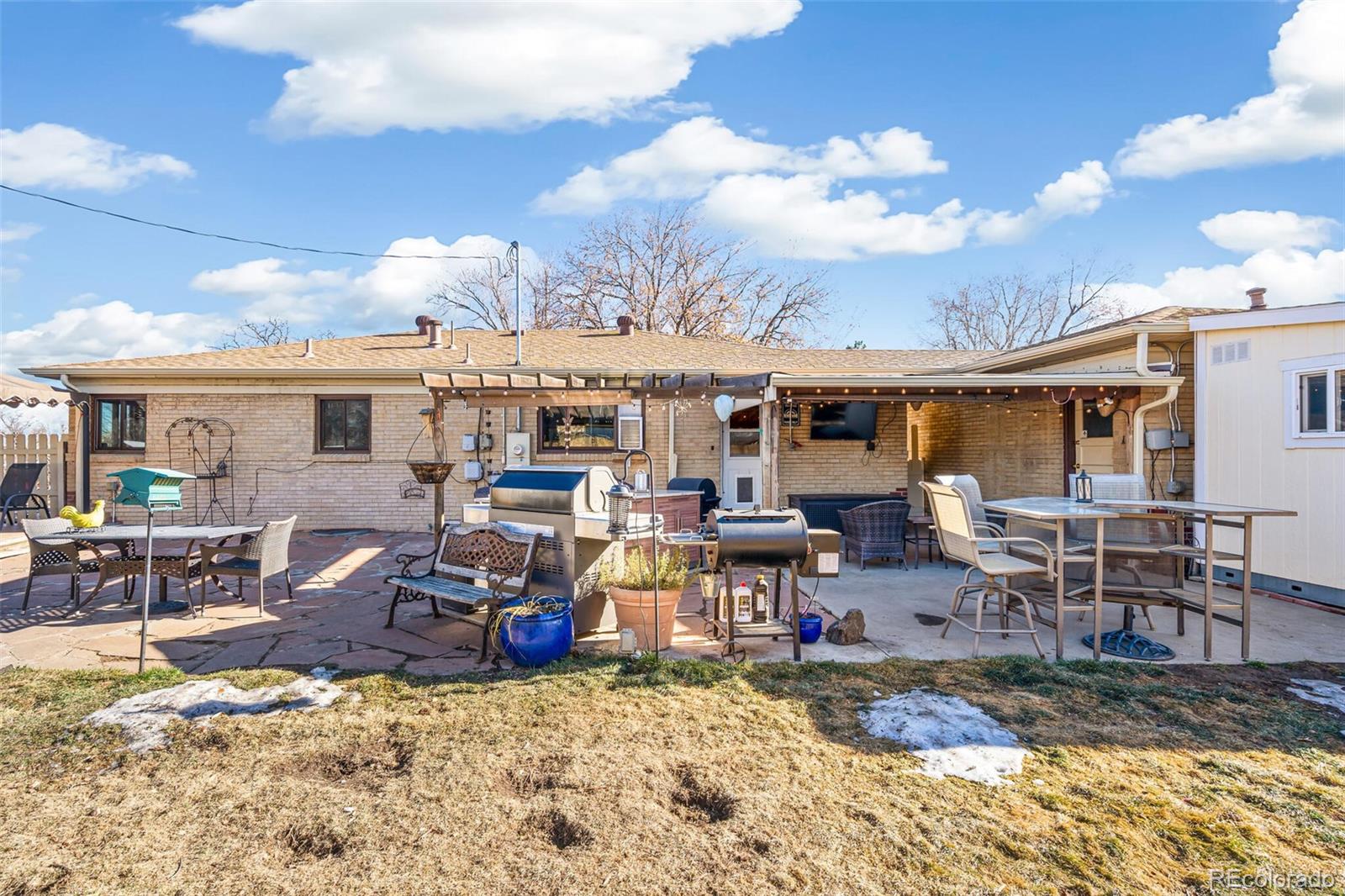 4155 Ingalls Street Wheat Ridge, CO 80033 - Photo 37 of 47 a view of a dinning table and chairs in the patio