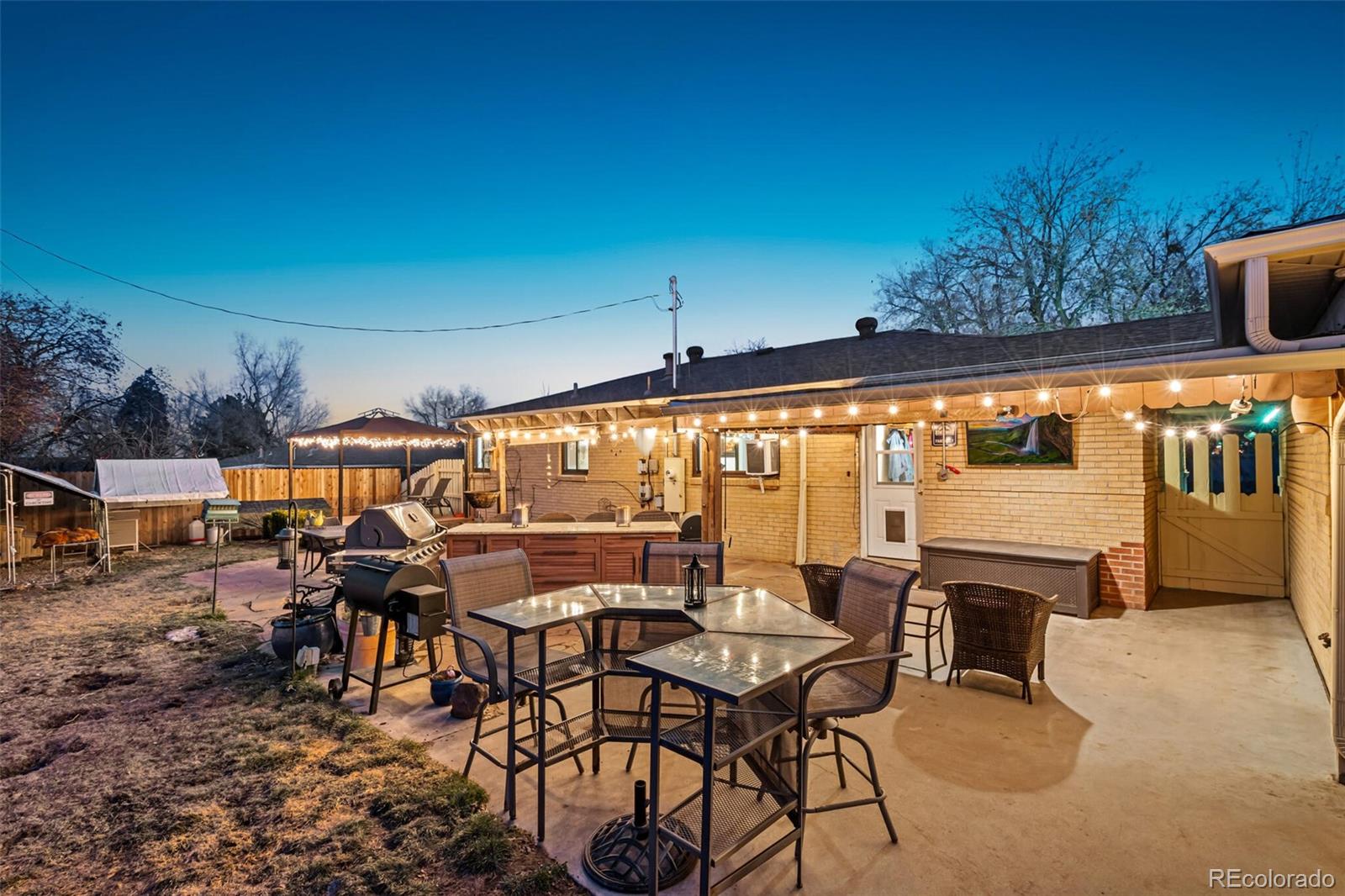 4155 Ingalls Street Wheat Ridge, CO 80033 - Photo 44 of 47 a view of a patio with a table and chairs