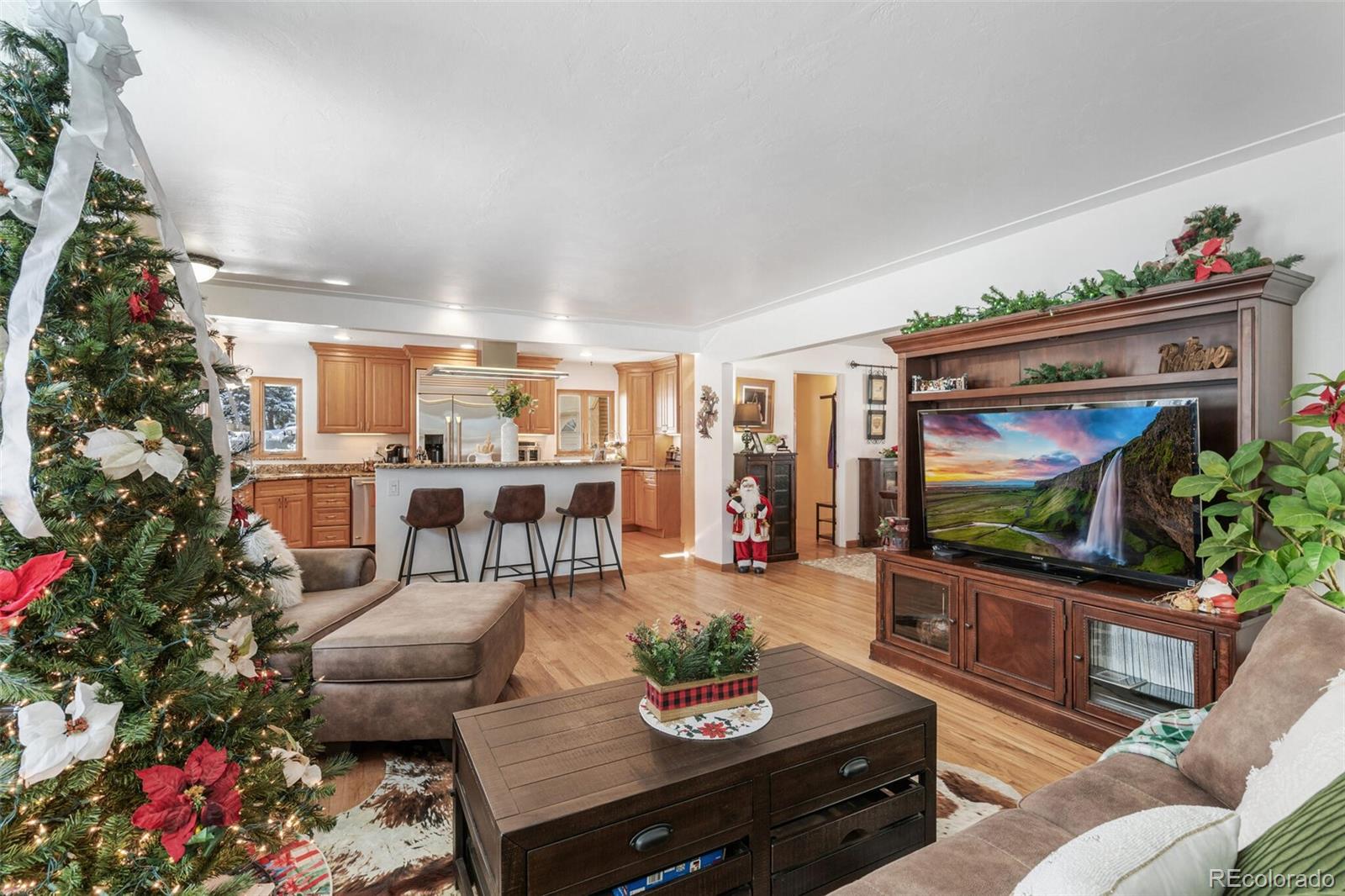 4155 Ingalls Street Wheat Ridge, CO 80033 - Photo 8 of 47 a living room with furniture and a flat screen tv