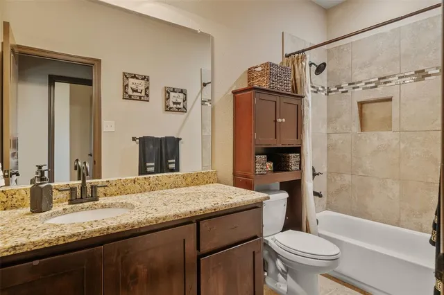 a room with wooden floor pool table furniture and windows
