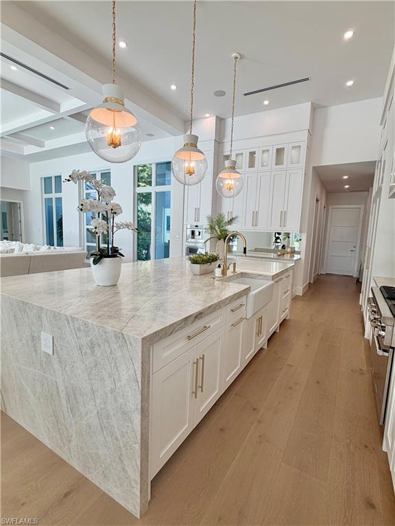 6824 Sable Ridge Lane Naples, FL 34109 - Photo 13 of 36 a large bathroom with a large tub and sink