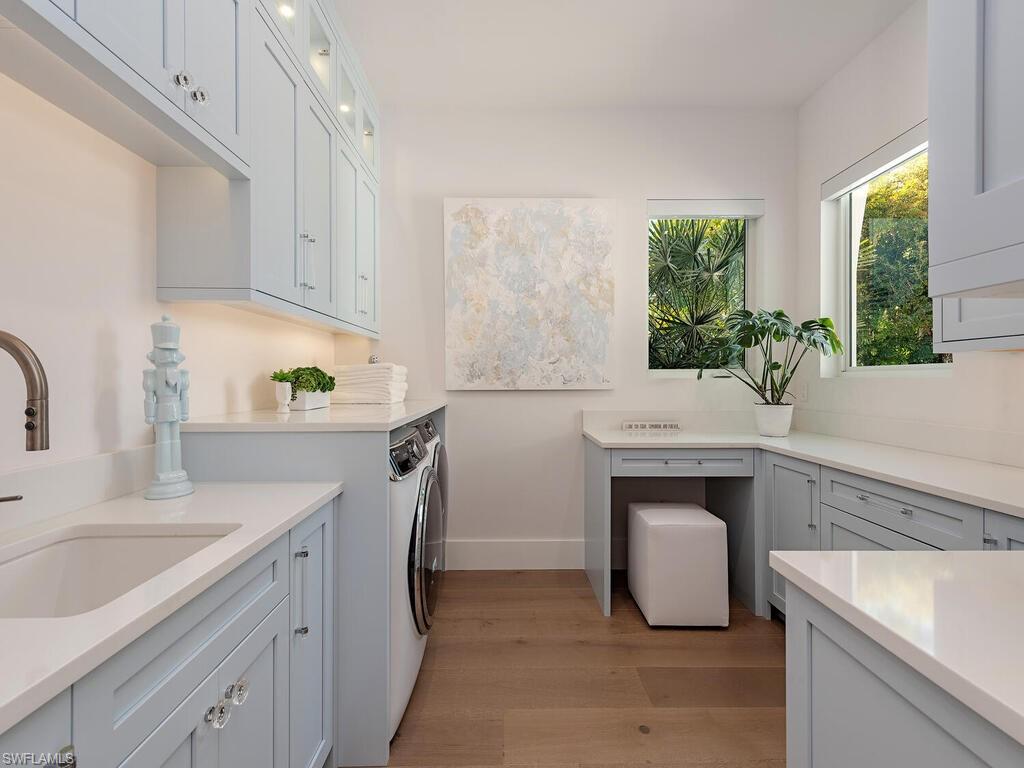 6824 Sable Ridge Lane Naples, FL 34109 - Photo 15 of 36 a kitchen with sink cabinets and window