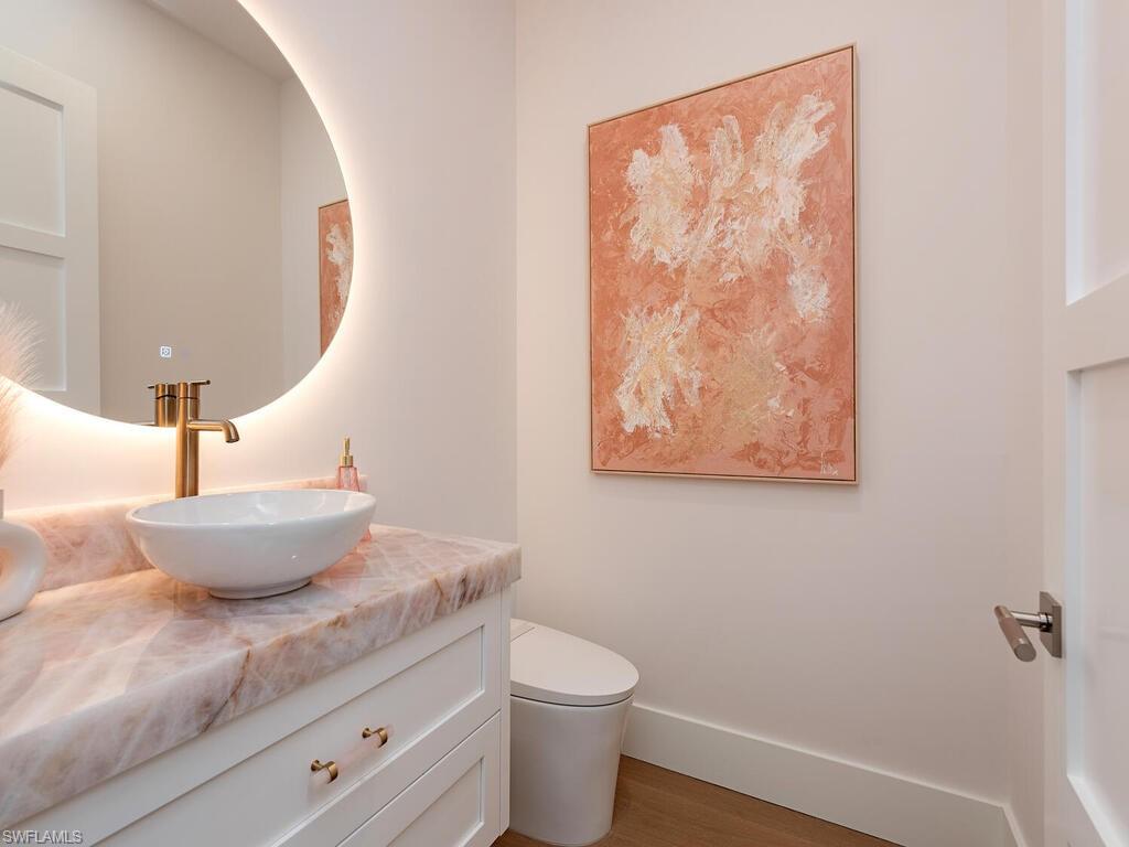 6824 Sable Ridge Lane Naples, FL 34109 - Photo 20 of 36 a bath room with a toilet and a sink