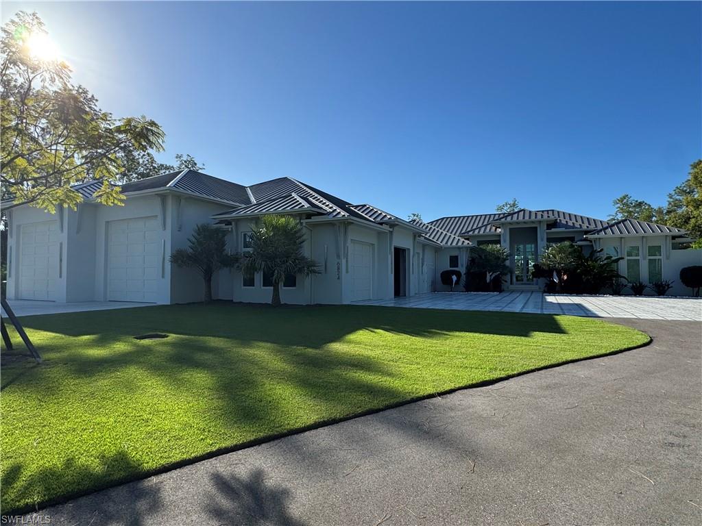 6824 Sable Ridge Lane Naples, FL 34109 - Photo 27 of 36 a view of a house with swimming pool and a yard