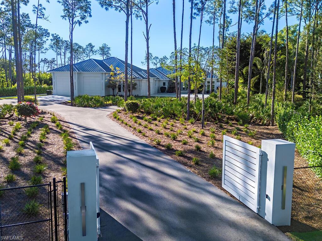 6824 Sable Ridge Lane Naples, FL 34109 - Photo 29 of 36 a view of a street with of flower plants