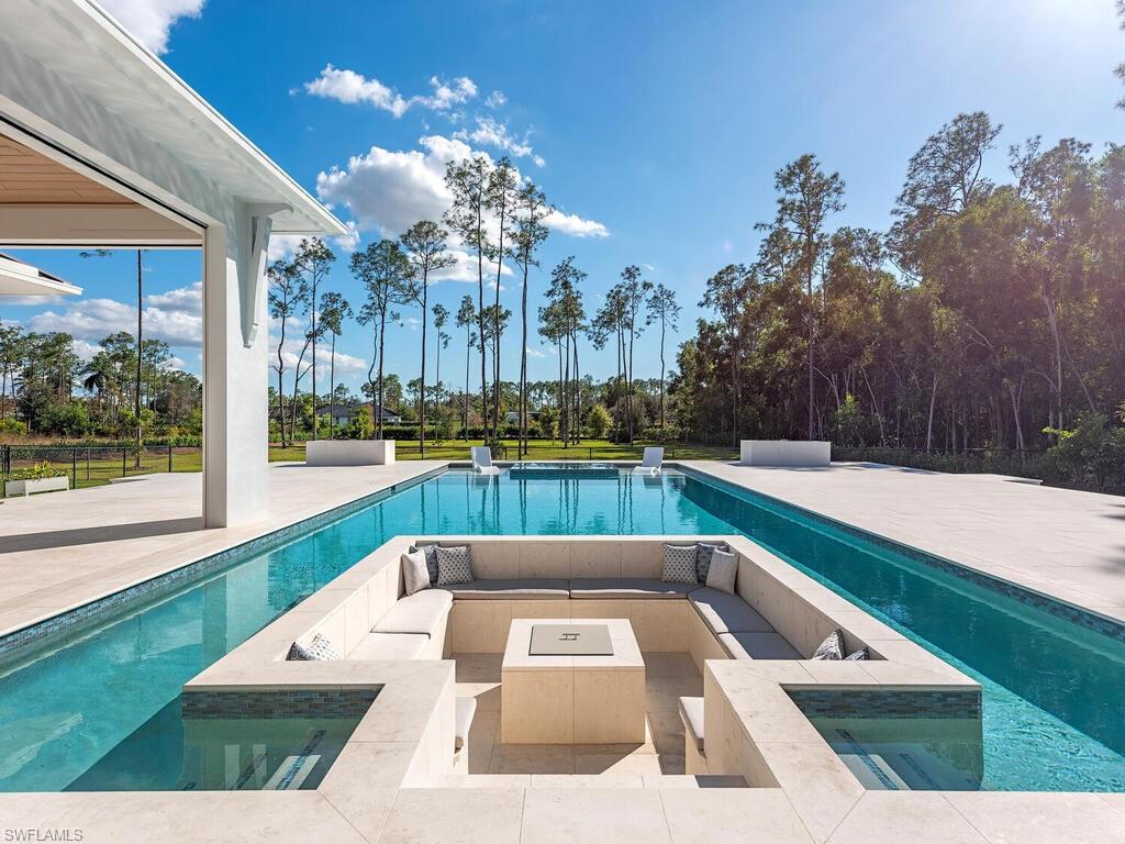 6824 Sable Ridge Lane Naples, FL 34109 - Photo 3 of 36 a view of swimming pool with outdoor seating and living room