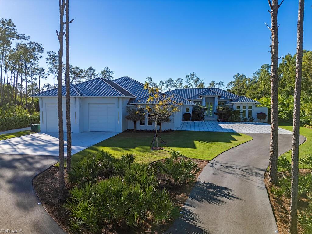 6824 Sable Ridge Lane Naples, FL 34109 - Photo 35 of 36 a view of a swimming pool with a yard