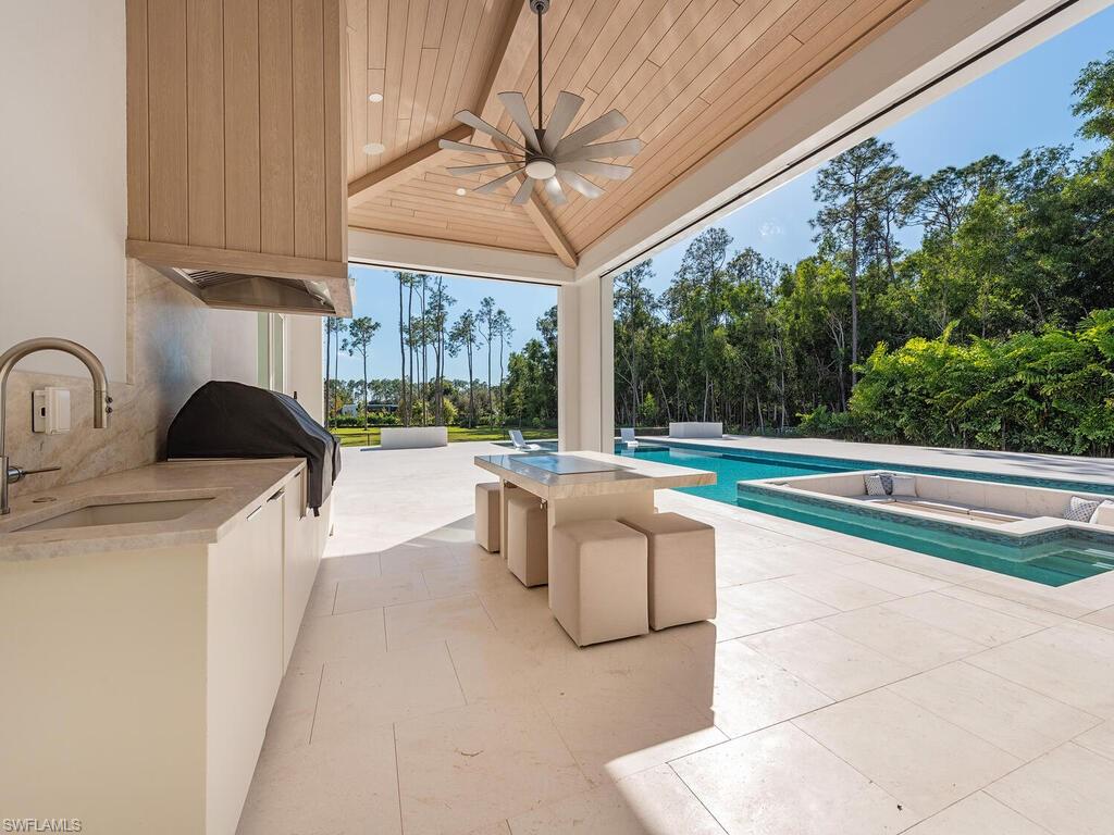 6824 Sable Ridge Lane Naples, FL 34109 - Photo 5 of 36 a view of a kitchen with a sink and living room