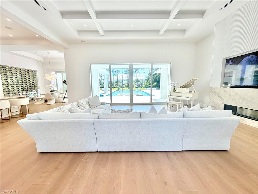 6824 Sable Ridge Lane Naples, FL 34109 - Photo 8 of 36 a living room with furniture and a large window