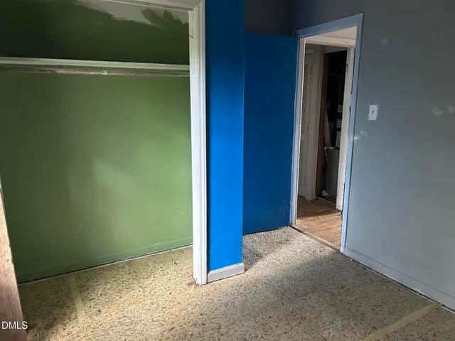 an empty room with wooden floor