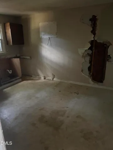 an empty room with wooden floor closet and windows