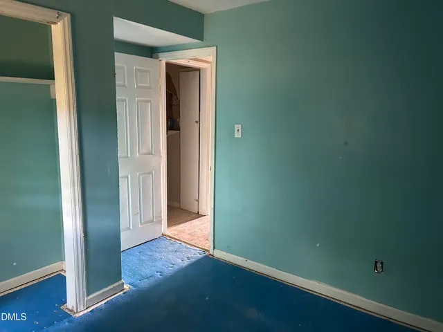 a room with wooden floor and lounge chair