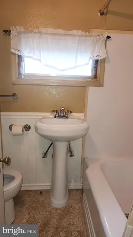 a bathroom with a sink toilet and a bathtub