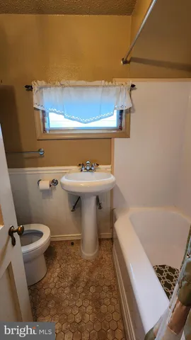 a bathroom with a sink a toilet and a bathtub