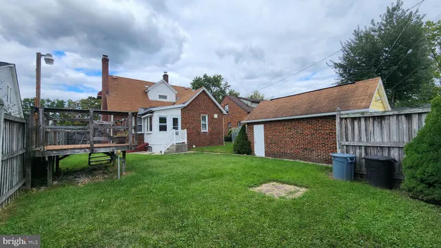a view of a house with a yard and sitting area