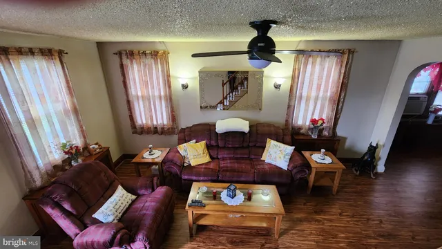 a living room with furniture and wooden floor