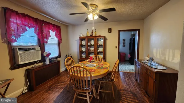a view of a dining room with furniture wooden floor and chandelier