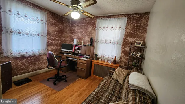 a view of a workspace with furniture and a chandelier