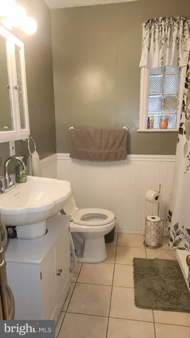 a bathroom with a sink toilet and mirror