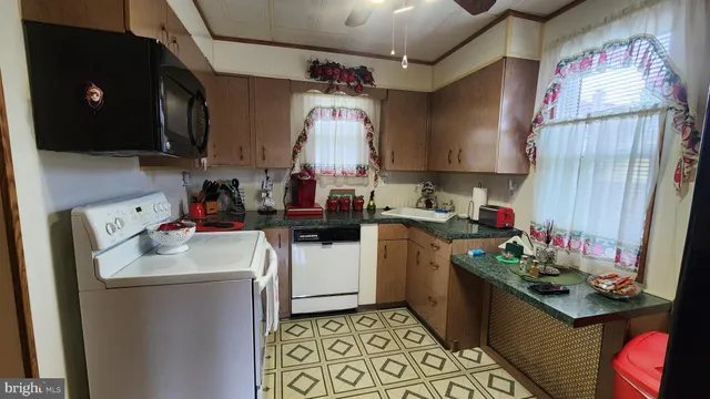 a kitchen that has a sink and a stove in it
