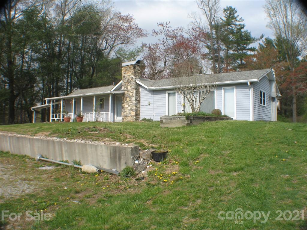 2060 Ridge Road Hendersonville, NC 28792 - Photo 1 of 21 a front view of a house with a yard and potted plants