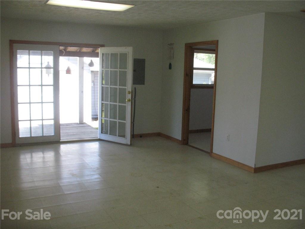 2060 Ridge Road Hendersonville, NC 28792 - Photo 15 of 21 an empty room with wooden floor and windows