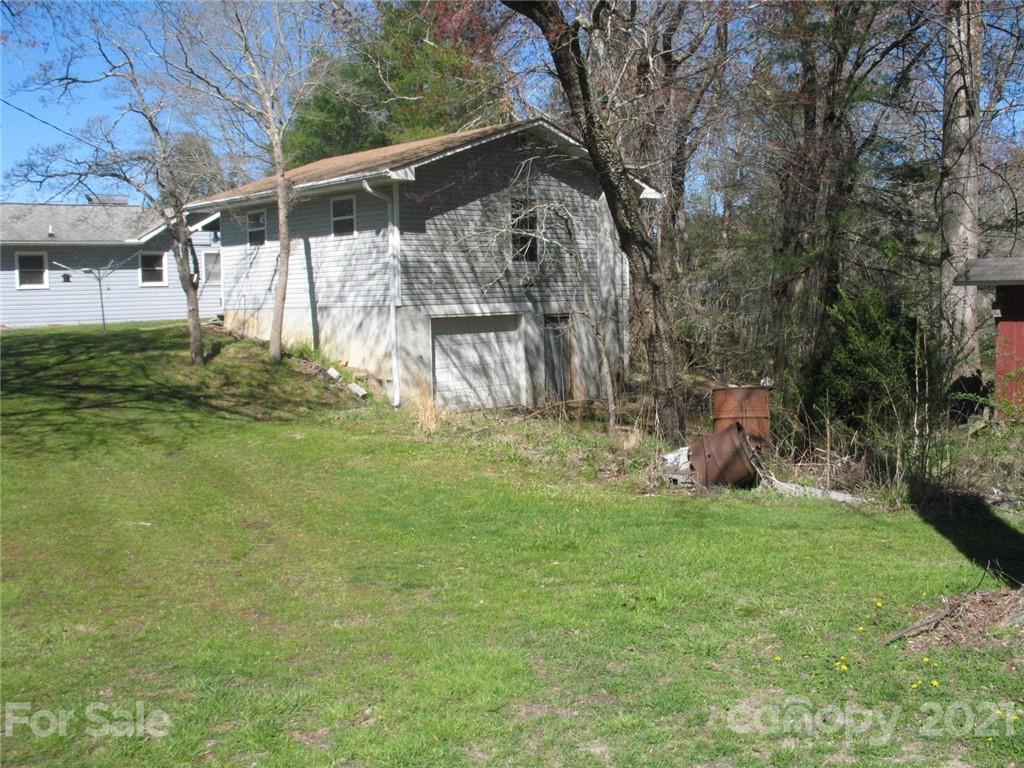 2060 Ridge Road Hendersonville, NC 28792 - Photo 16 of 21 a view of a backyard with table and chairs and potted plants