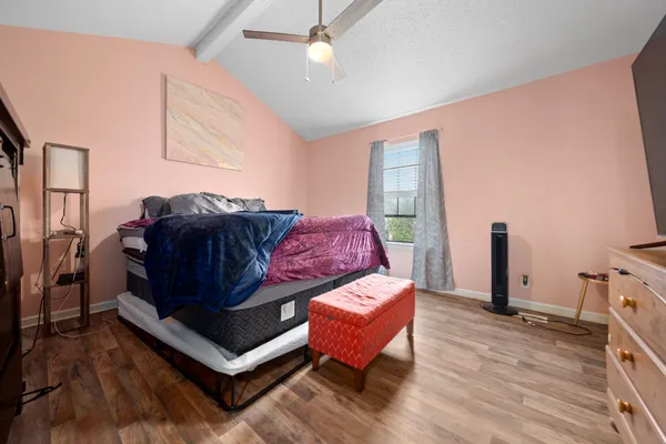 a living room with a bed furniture and a flat tv screen