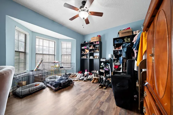 a living room with furniture a flat screen tv and a window