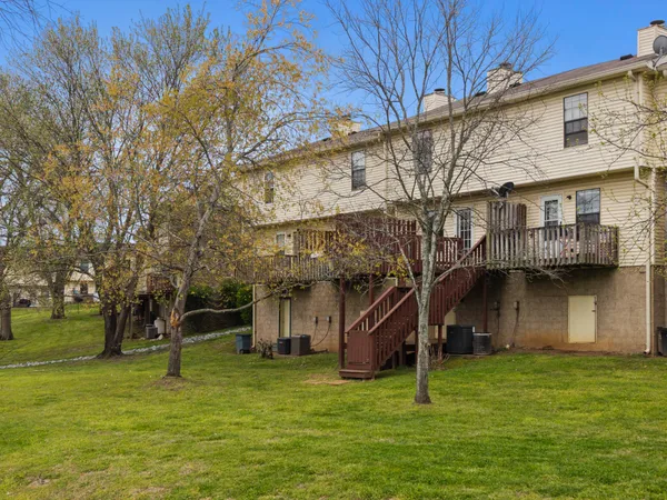a house with a big yard and large trees