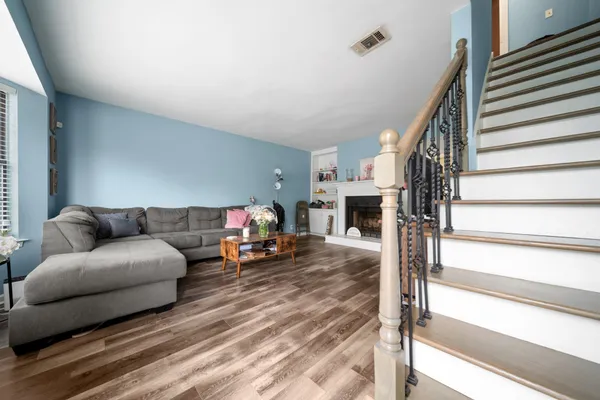 a living room with furniture and a fireplace