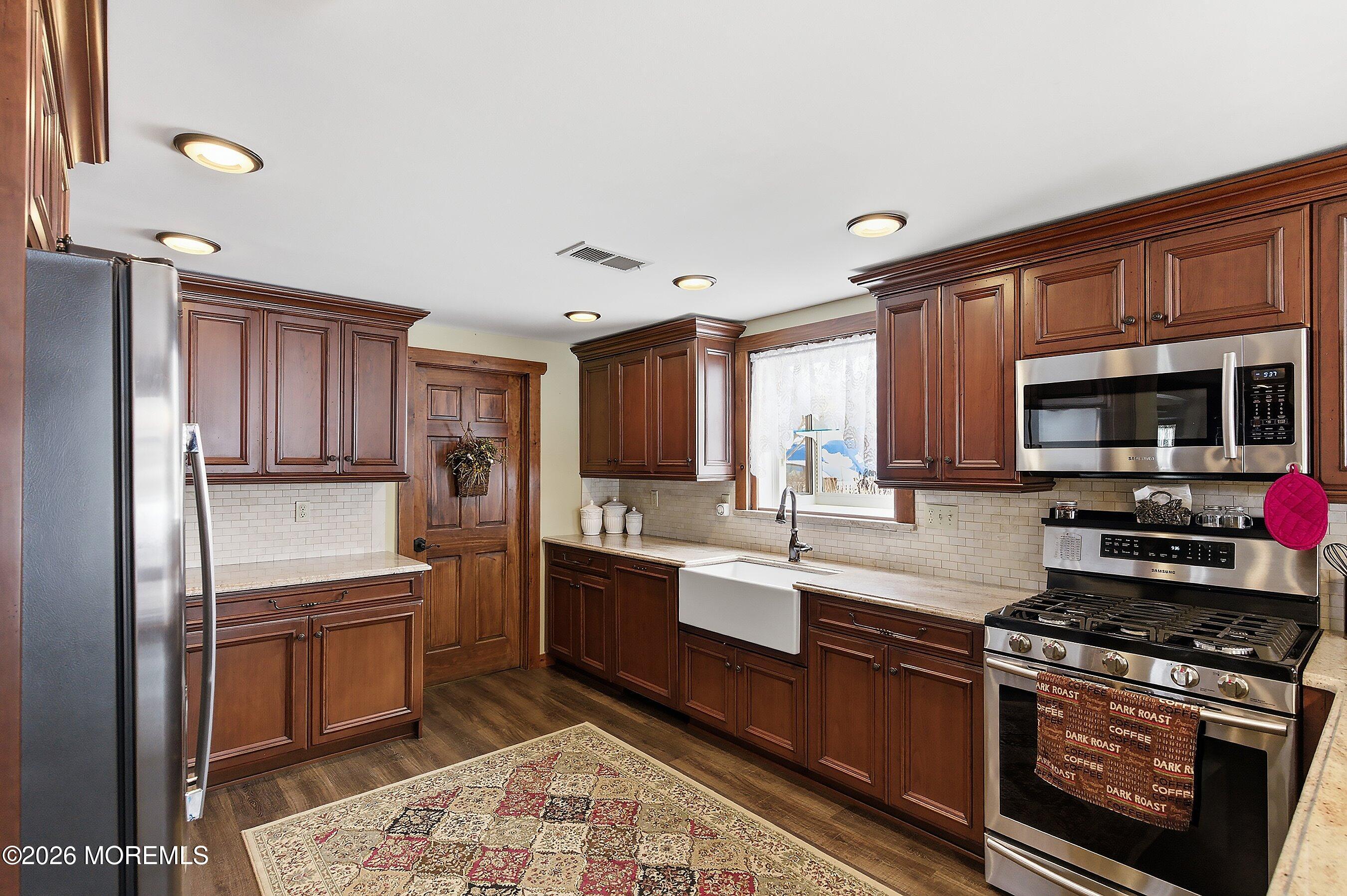 515 Carroll Fox Road Brick, NJ 08724 - Photo 34 of 60 a kitchen with stainless steel appliances granite countertop a refrigerator stove and sink