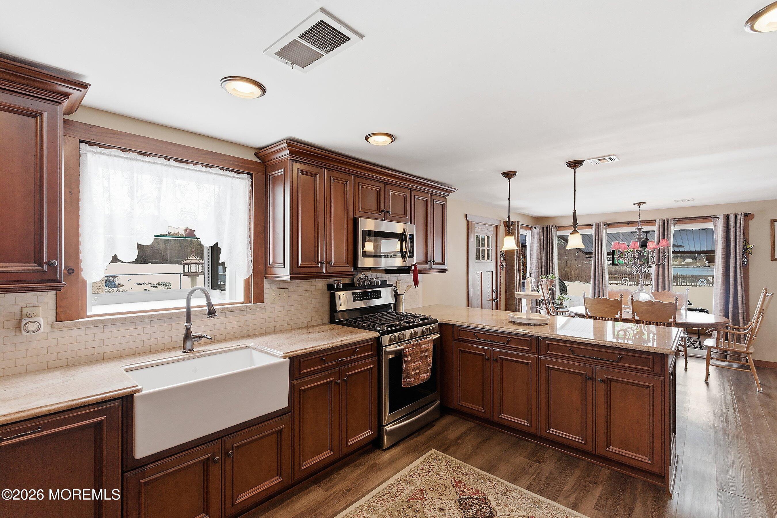 515 Carroll Fox Road Brick, NJ 08724 - Photo 37 of 60 a kitchen with a sink stove and cabinets