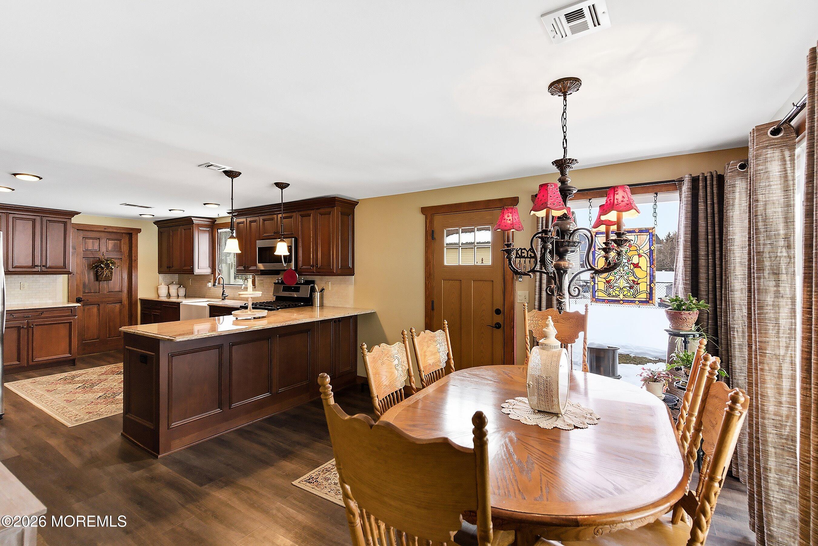 515 Carroll Fox Road Brick, NJ 08724 - Photo 40 of 60 a view of a dining room and livingroom with furniture wooden floor a chandelier