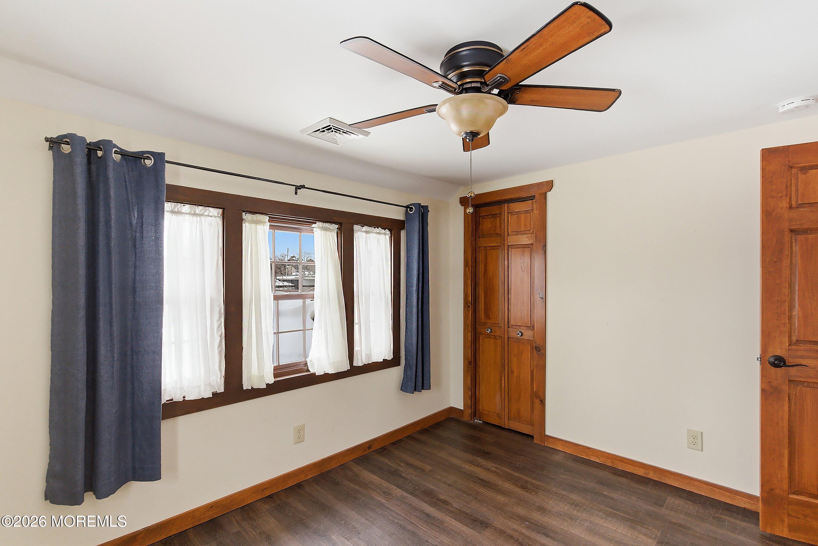 515 Carroll Fox Road Brick, NJ 08724 - Photo 55 of 60 a view of an empty room with a window and wooden floor