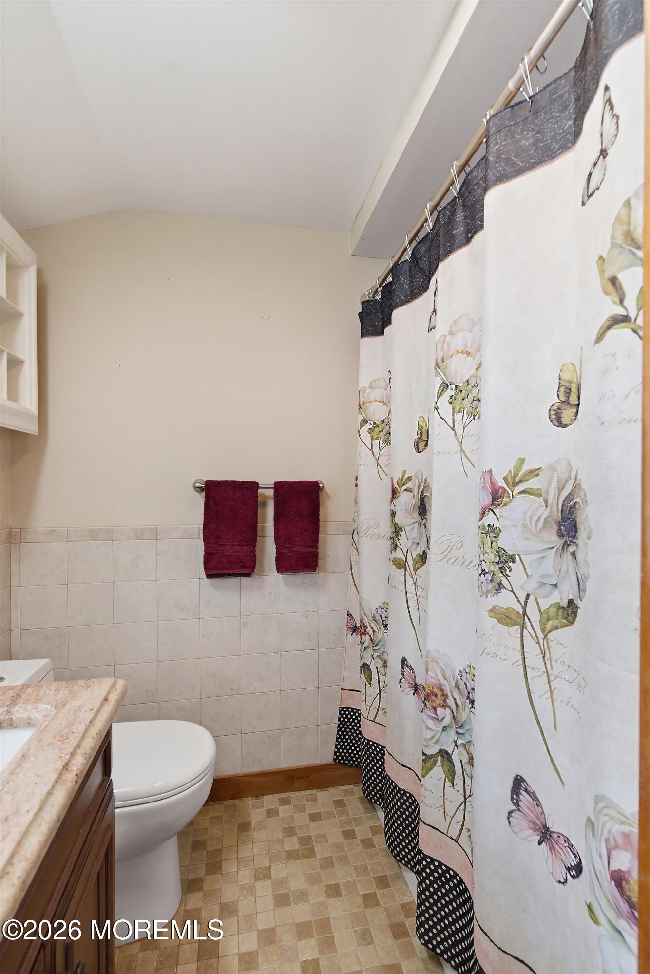 515 Carroll Fox Road Brick, NJ 08724 - Photo 57 of 60 a bathroom with a toilet and a shower curtain