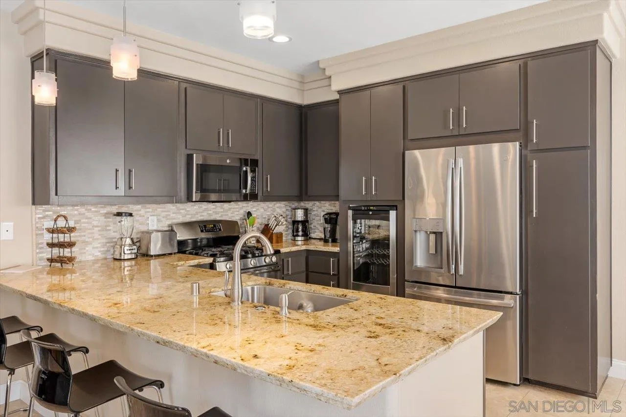 312 Bonair Street La Jolla, CA 92037 - Photo 11 of 40 a kitchen with stainless steel appliances granite countertop a sink refrigerator and cabinets