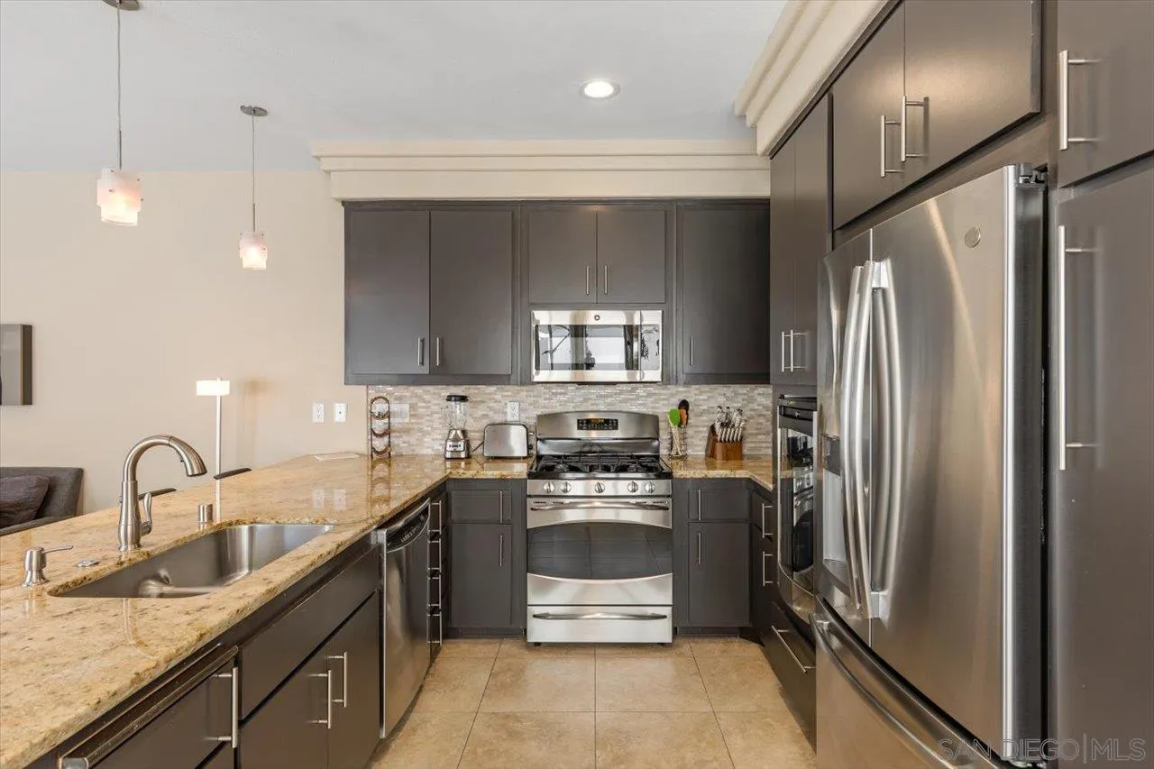 312 Bonair Street La Jolla, CA 92037 - Photo 12 of 40 a kitchen with stainless steel appliances a sink stove and refrigerator