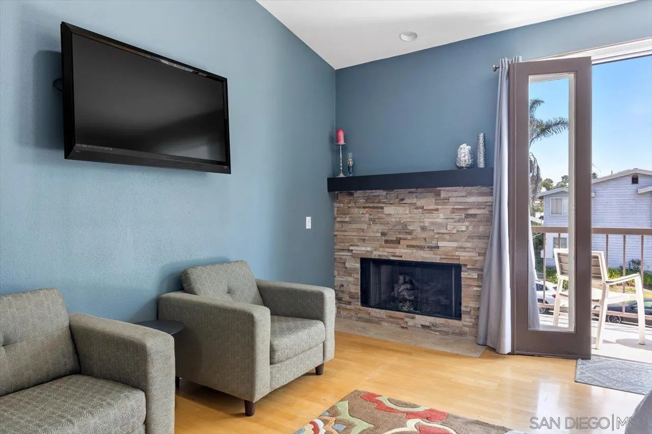 312 Bonair Street La Jolla, CA 92037 - Photo 16 of 40 a living room with a flat screen tv and a fireplace