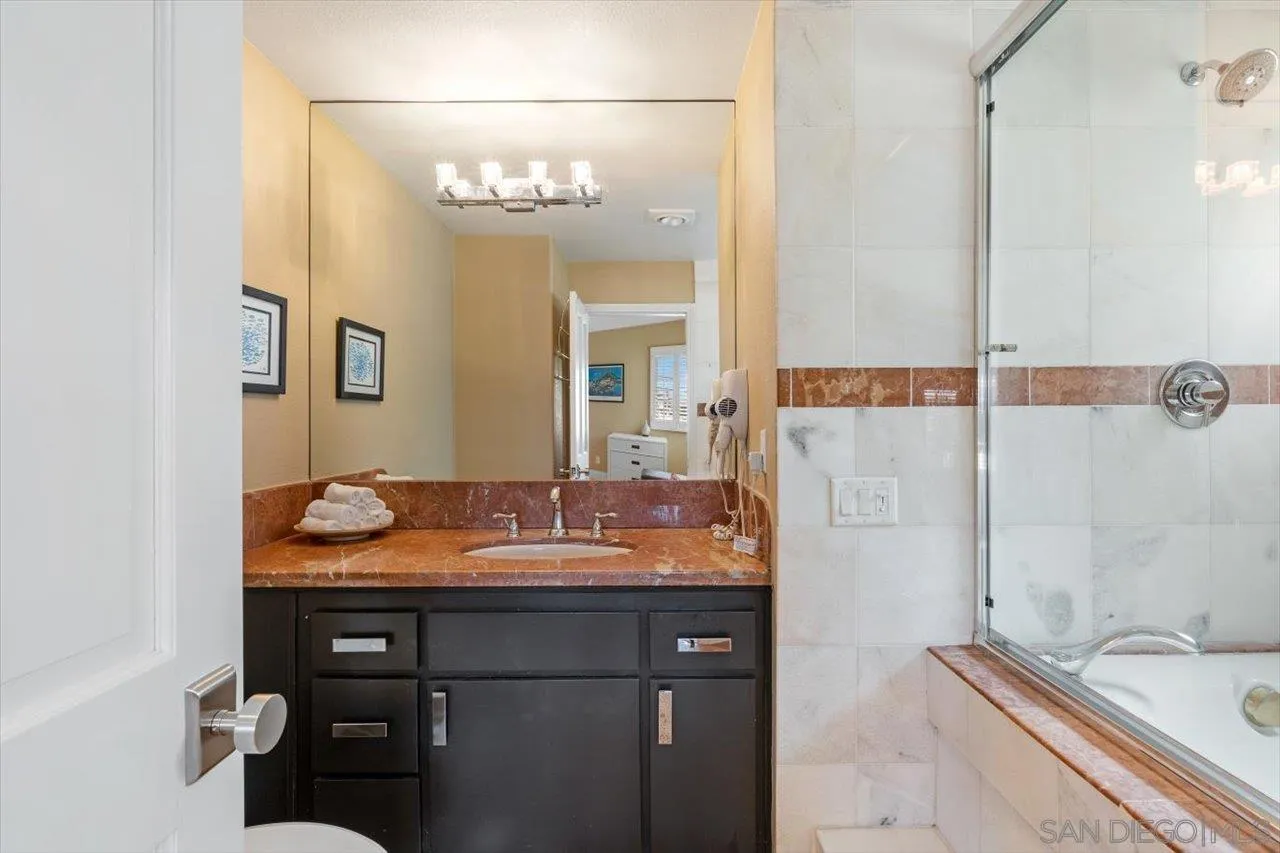 312 Bonair Street La Jolla, CA 92037 - Photo 26 of 40 a bathroom with a granite countertop sink and a mirror