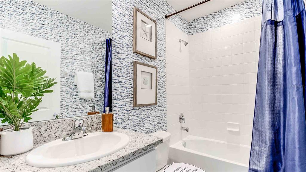 17527 Maple Grv Road Land O Lakes, FL 34638 - Photo 13 of 17 a bathroom with a granite countertop sink and a mirror