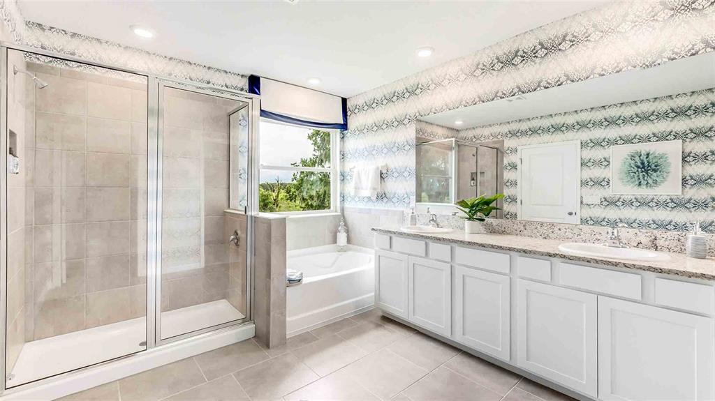 17527 Maple Grv Road Land O Lakes, FL 34638 - Photo 15 of 17 a bathroom with a double vanity sink and a bathtub