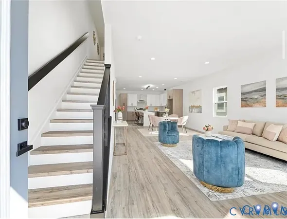 a living room with furniture and a wooden floor