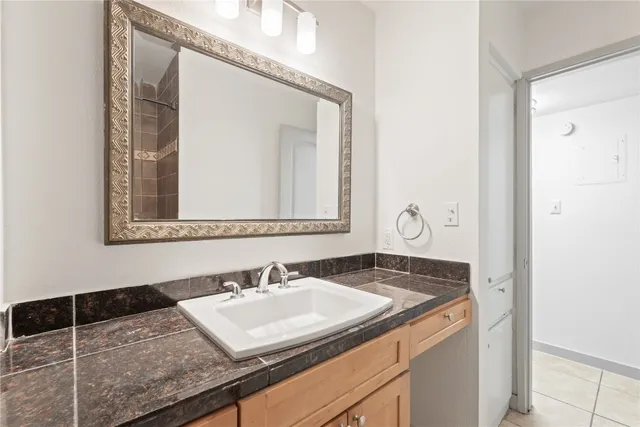 a bathroom with a sink vanity and a mirror