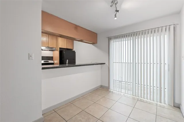 a view of a hallway to rooms and stairs