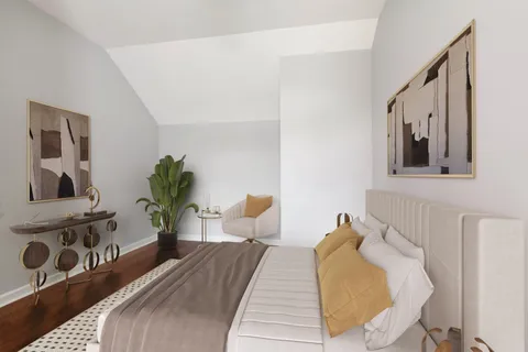 a bed room with a bed and a potted plant