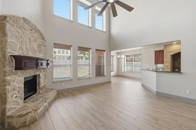 a view of a livingroom with wooden floor and a fireplace