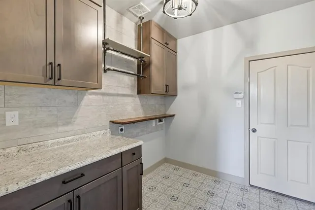 a kitchen with a sink a refrigerator and cabinets