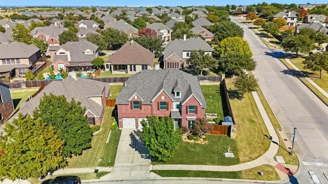 an aerial view of residential houses with outdoor space and swimming pool